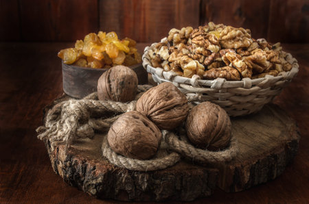 Walnuts and other fruits on dark wooden background