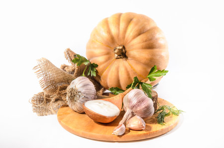 pumpkin and ingredients for sour cream sauce on a light backgroundの写真素材