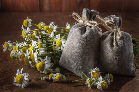 Medicinal herbs in burlap bags on an old wooden background, herbal medicine.の写真素材