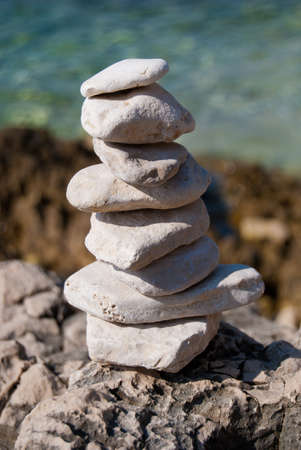 Small stone pyramid against natural backgroundの写真素材