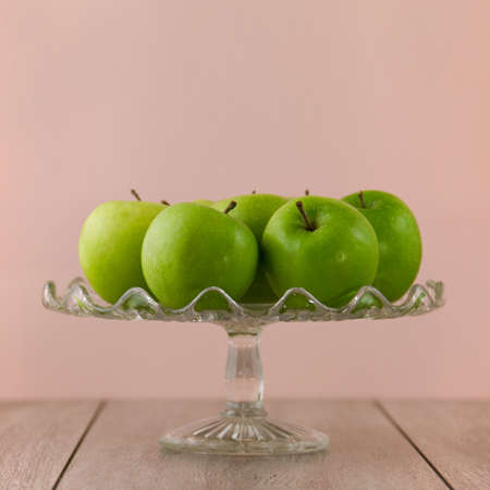 Green apples on pinkの写真素材