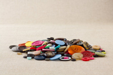 Many mixed, brightly coloured sewing or clothing buttonsの写真素材