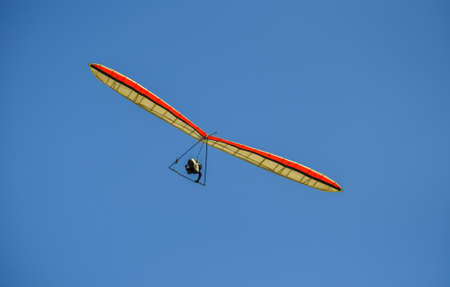 Paraglider enjoying the currents in the blue sky.の写真素材