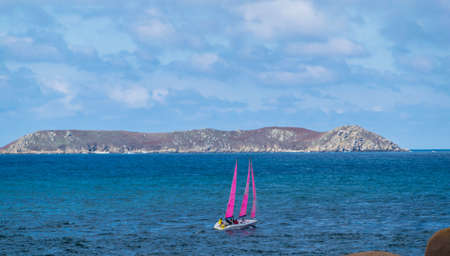 Boat with pink sails, sailing along the pink granite coast, in the C?tes-d'Armor, Brittany, France.のeditorial素材
