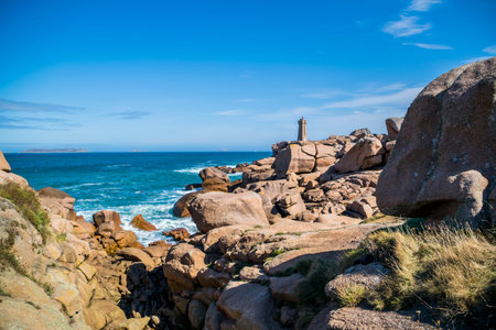 The pink granite coast at Ploumanac'h with the Mean Ruz lighthouse in CÃ´tes-d'Armor in the Brittany region, France.の写真素材