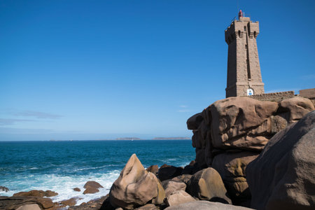 The pink granite coast at Ploumanac'h with the Mean Ruz lighthouse in CÃ´tes-d'Armor in the...