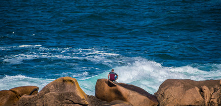 The pink granite coast at Ploumanac'h with the Mean Ruz lighthouse in CÃ´tes-d'Armor in the...