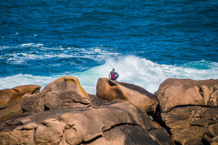 The pink granite coast at Ploumanac'h with the Mean Ruz lighthouse in CÃ´tes-d'Armor in the Brittany region, France.の写真素材