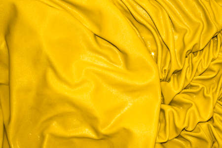 Yellow bright silk background.Yellow silk texture.の写真素材