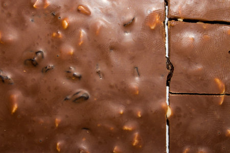 Texture of milk chocolate with raisins and nuts .Chocolate top view.