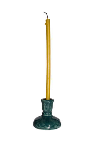 Church candle in a candlestick on a white background.の写真素材