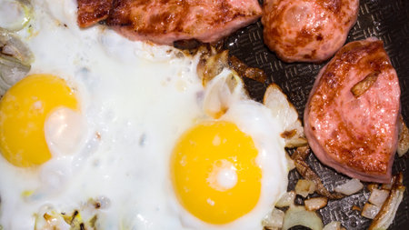 The eggs and sausage. Background scrambled eggs with sausage. Fried eggs with sausage.の写真素材