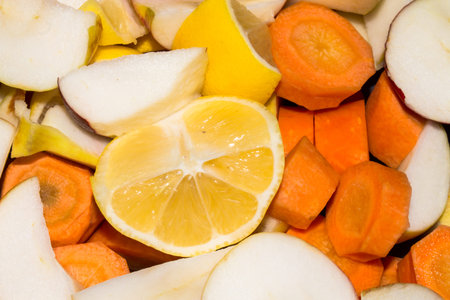 Cut into pieces fruits and vegetables. Background of chopped vegetables and fruits. Fruits and...