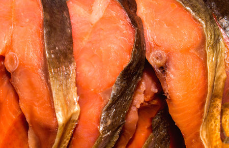 Red smoked fish.Background of pieces of red fish.Red fish cut into pieces.