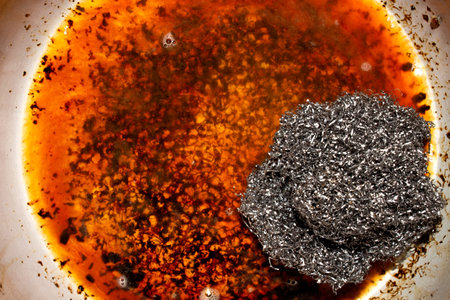 A dirty pot. Burnt dishes. Background with a dirty pan.