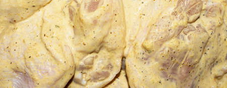 Chicken kebab in a marinade with spices. Raw chicken in a sauce with spices.の写真素材