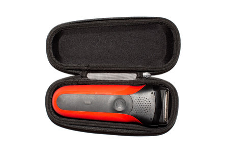 Electric razor in a case on a white background.