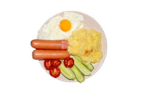 Mashed potatoes with egg, sausage and vegetables on a plate.の写真素材