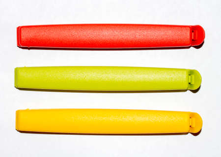 Plastic bag clips on a white background. Colored clothespins for open packages.の写真素材