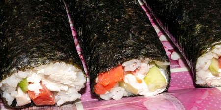 Sushi with fish and cucumber. Sushi prepared at home.の写真素材