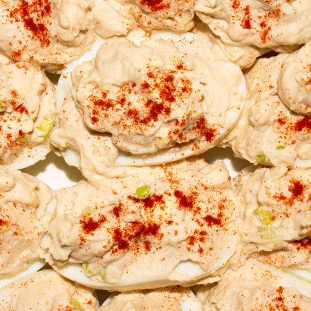 Boiled eggs stuffed with cod liver. Background of eggs stuffed with cod liver top view.