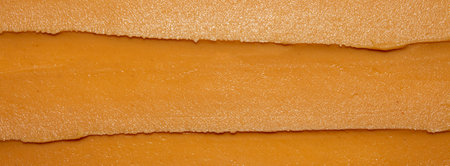 Light brown peanut paste made from whole nuts.Peanut paste background top view.Peanut paste texture top view.Peanut butter cream for spreading.の写真素材