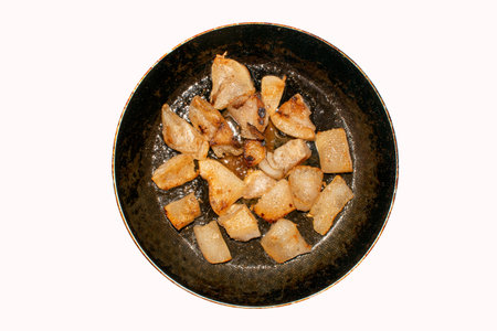 Fried pork fat background top view. Homemade pork rinds made from lard.
