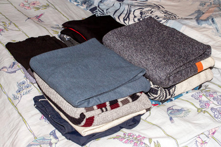 The clothes are stacked neatly in a pile.Neatly folded things.The clothes are beautifully...