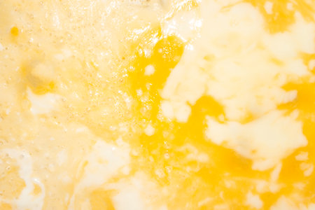 Fried beaten egg. Omelet background.Fried egg with beaten yolk.Egg omelet.の写真素材