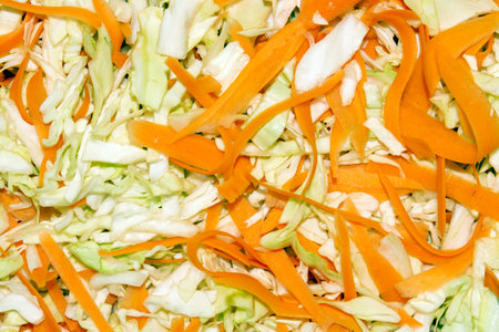 Shredded cabbage with carrots for sourdough.Finely chopped cabbage and carrots.Home-made sauerkraut.Shredded cabbage background.の写真素材