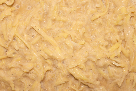 The mass for making potato pancakes.Grated potatoes with egg and spices.Consistency for pancakes.