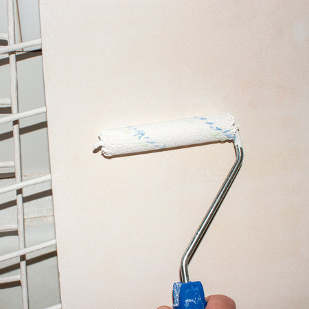 Painting the surface with acrylic white paint.Roller painting on wood with acrylic paint.Painting work.Coloring background.の写真素材