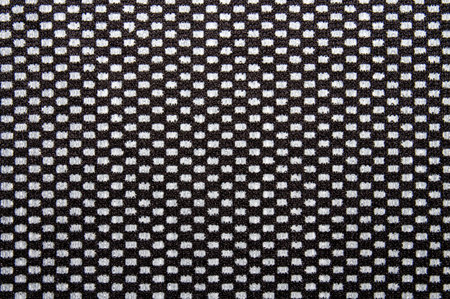 The texture is made of black and white fabric in a checkerboard pattern.The checkerboard background...