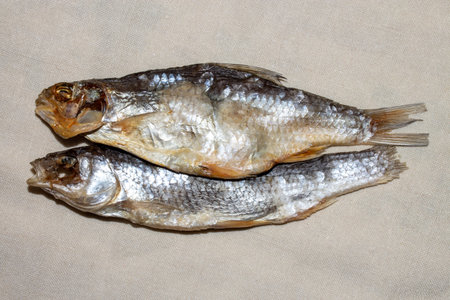 Dried roach fish with caviar. Dried fish background. Appetizer for beer.