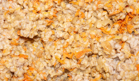 Pearl barley with onion and carrot texture.Pearl barley homemade view from above.Boiled pearl barley background.Pearl barley photo.の写真素材