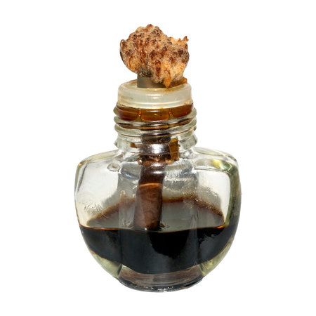 An air freshener filled with tar on a white background.Tar in a glass bottle.Liquid tar for the smell.の写真素材