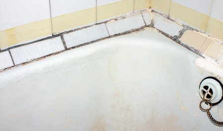 Old dirty bathtub in the bathroom of a country house in Thailand.の写真素材