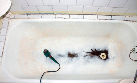 Cast-iron bathtub for restoration.An old cast-iron bathtub for acrylic coating.Cast-iron bathtub after cleaning.An old bathtub for restoration with enamel or acrylic.The bathroom is worn out.の写真素材