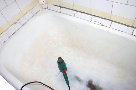 Hair dryer in a bathtub, closeup of photoの写真素材