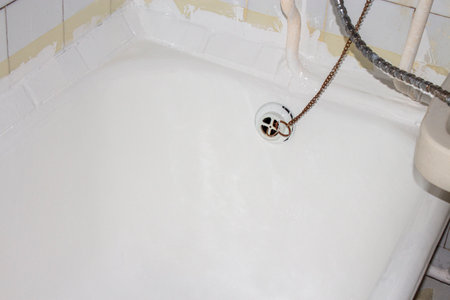 Cast-iron bathtub covered with self-leveling acrylic.Restoration of the bathtub with self-leveling acrylic.Restoration of an old bathtub.Acrylic bathtub background.の写真素材