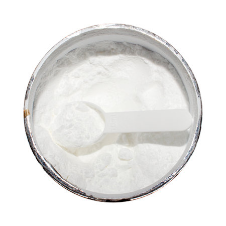 Creatine in a measuring plastic spoon on a white background.Creatine monohydrate.Creatine for endurance in training.Creatine powder background.の写真素材