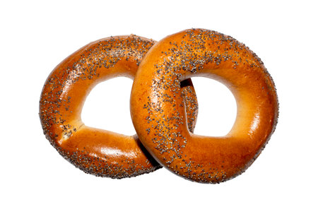Vanilla bagel with poppy seeds on a white background.A bagel is a sweet bun.Bagel background.Baking a bagel.の写真素材