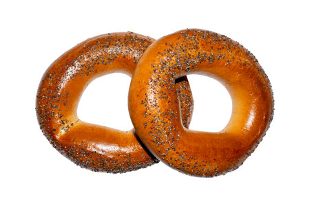 Vanilla bagel with poppy seeds on a white background.A steering wheel with a poppy on a white background.A bagel is a sweet bun.Bagel background.Baking a bagel.の写真素材