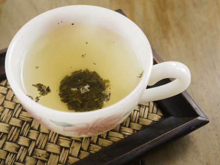 hot tea cup on the bamboo trayの写真素材