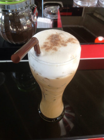 A glass of ice cappuccino Top with a deep layer of foam