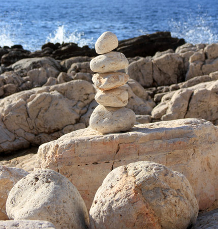 A pile of stacked stones near the seaの写真素材