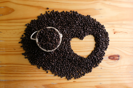 Roasted coffee bean in small sack with heart shapeの写真素材