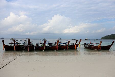Kolae boats park on the beach at Lipe island, Thailandの写真素材