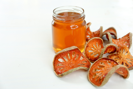 Honey and dry bael fruit with copy spaceの写真素材