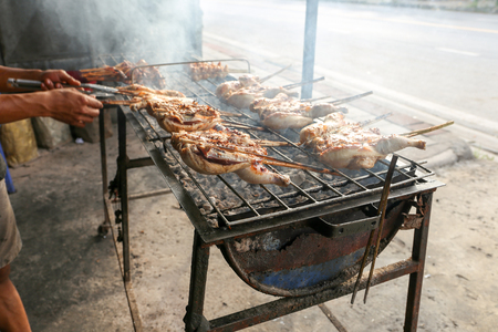 Local seller make Thai style roasted chicken, Thailand street foodの写真素材